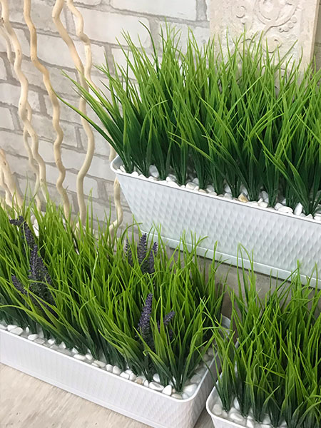 Vases with artificial grass or lavender flowers are an excellent interior solution for an office, terrace, public institution or apartment.