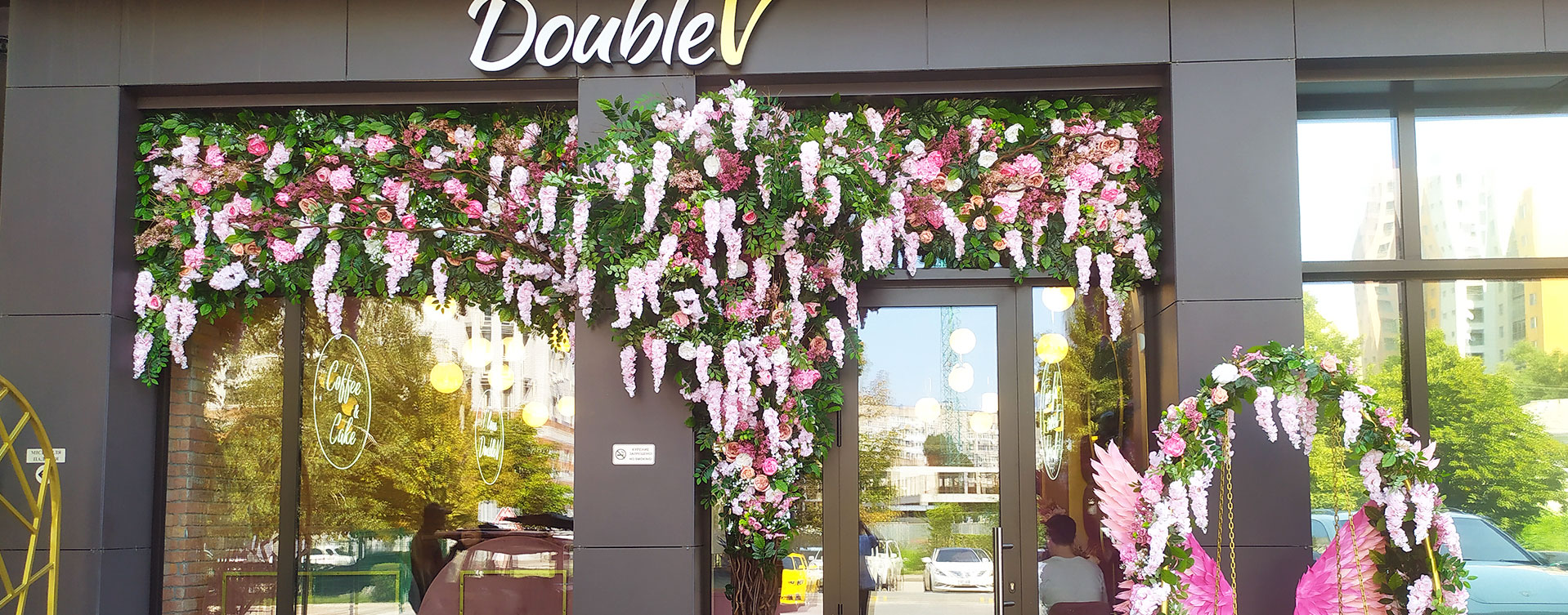 Cafe window decoration with artificial flowers