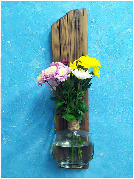 A set of 3 bottles on a wooden driftwood. A vase for flowers, buy for a summer cafe