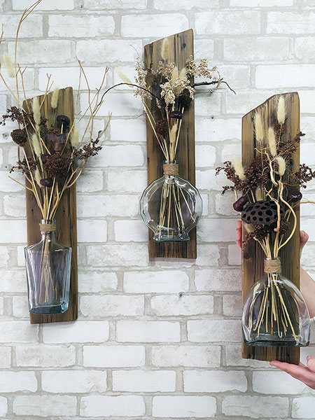 Hanging water vases. Wall vase on driftwood, shabby chic wood. Germany, Austria, Switzerland